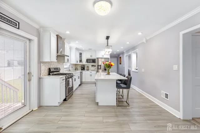 a kitchen with a sink appliances and cabinets