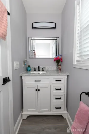 a bathroom with a sink vanity and a mirror