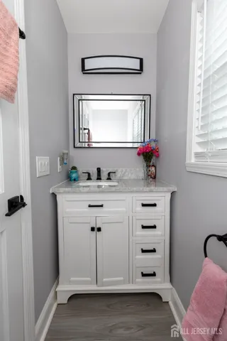 a bathroom with a sink vanity and a mirror