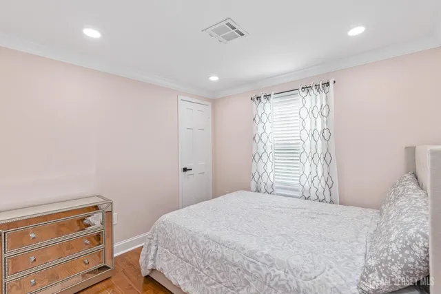 a bedroom with a bed and a dresser