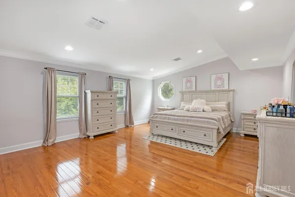 a spacious bedroom with a bed and a cabinets