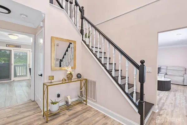 a view of entryway and hall with wooden floor