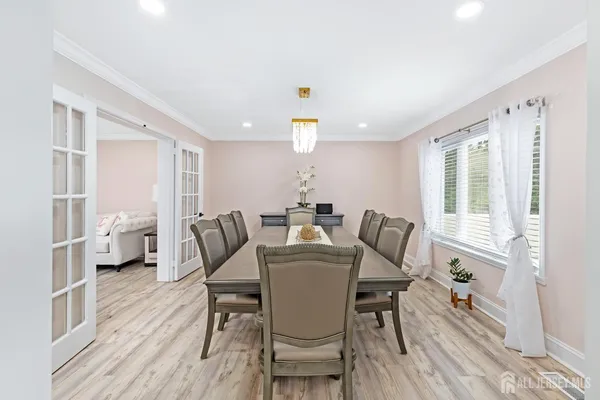 a dining room with furniture and wooden floor