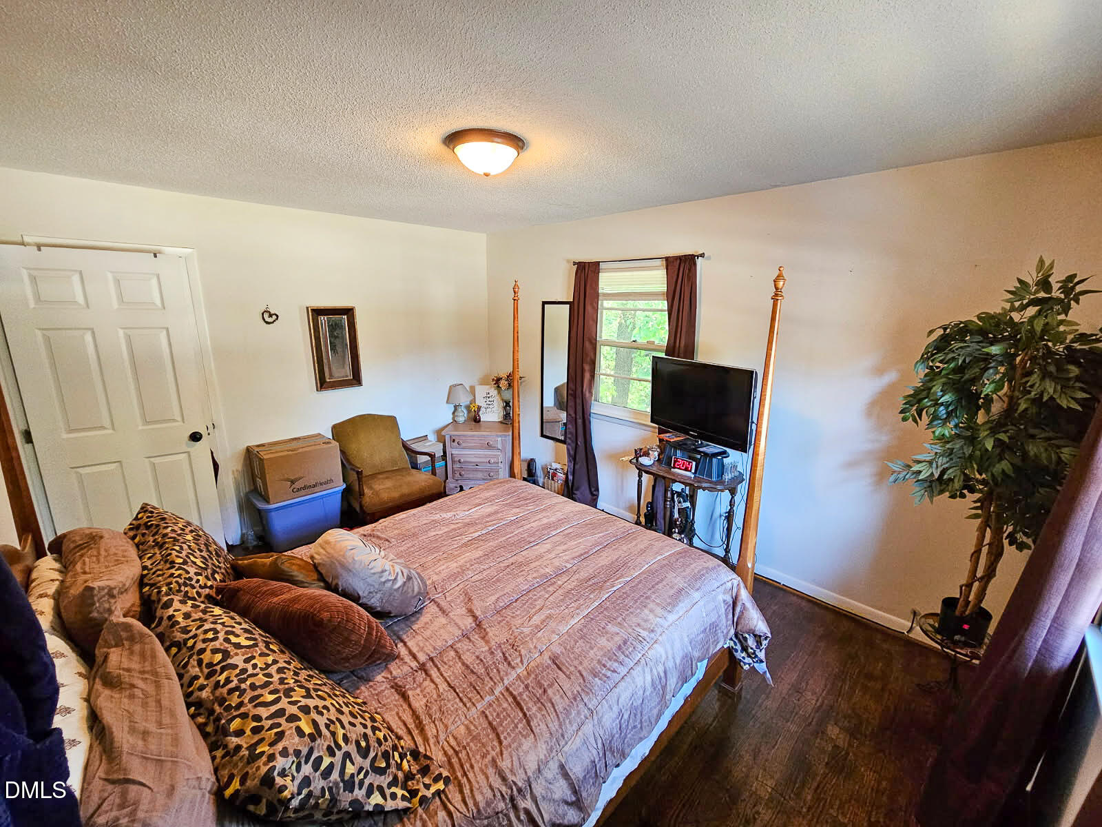 2212 Sanderford Road Raleigh, NC 27610 - Photo 15 of 28 a bedroom with a bed and a flat screen tv
