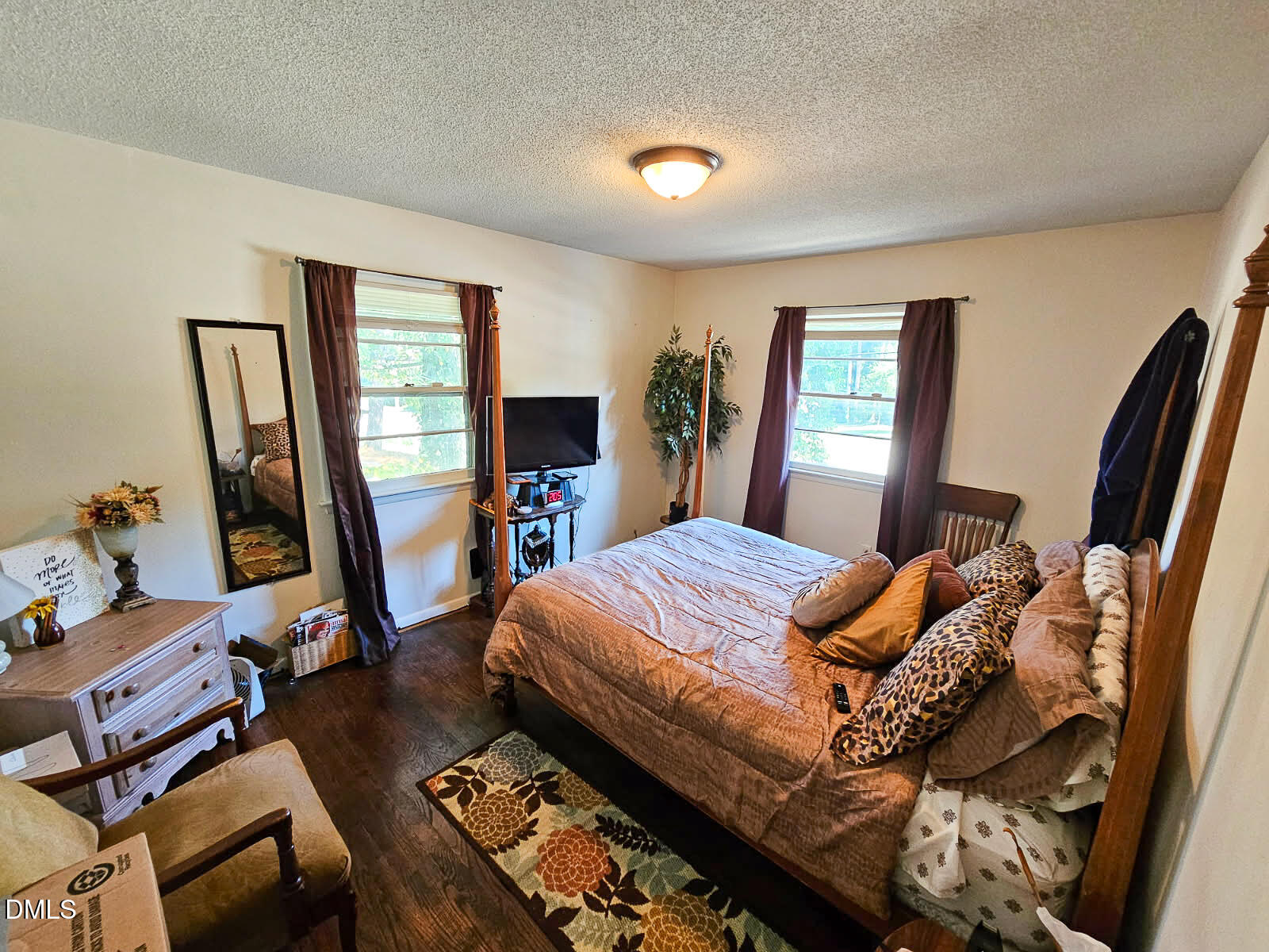 2212 Sanderford Road Raleigh, NC 27610 - Photo 16 of 28 a bed room with a bed and a flat screen tv