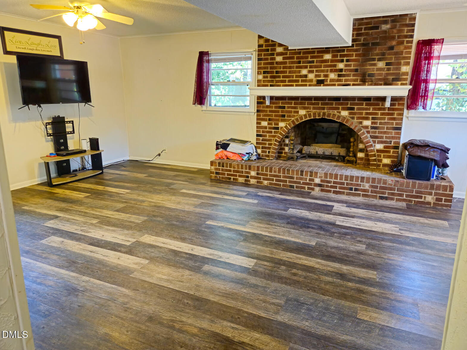 2212 Sanderford Road Raleigh, NC 27610 - Photo 22 of 28 a fireplace with a flat screen tv and a fireplace