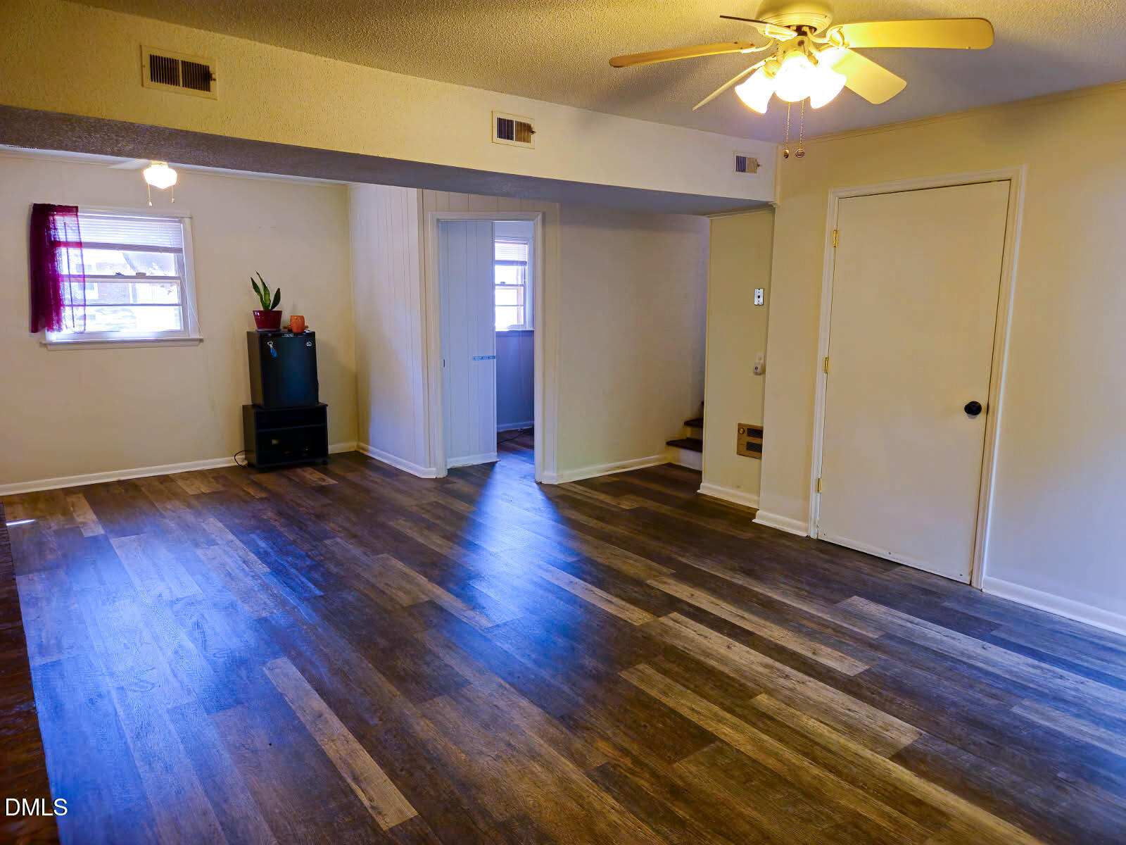 2212 Sanderford Road Raleigh, NC 27610 - Photo 24 of 28 a living room with hard wood floors and a ceiling fan