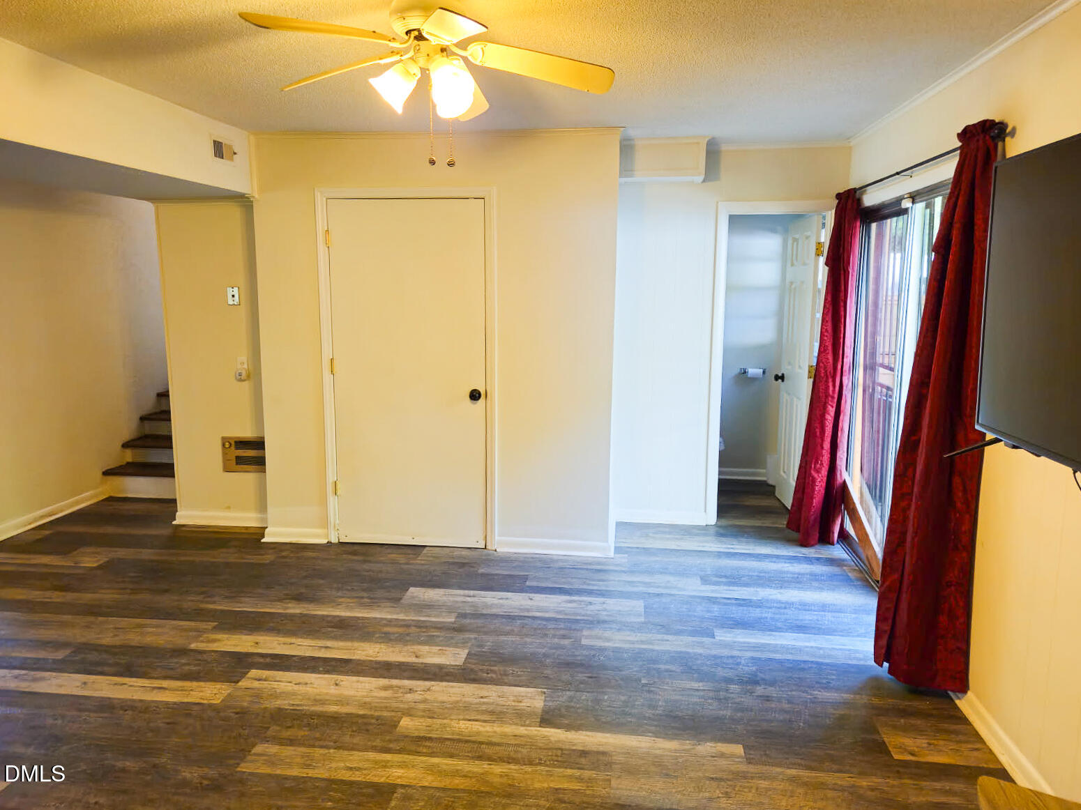 2212 Sanderford Road Raleigh, NC 27610 - Photo 25 of 28 a view of a room with wooden floor and stairs