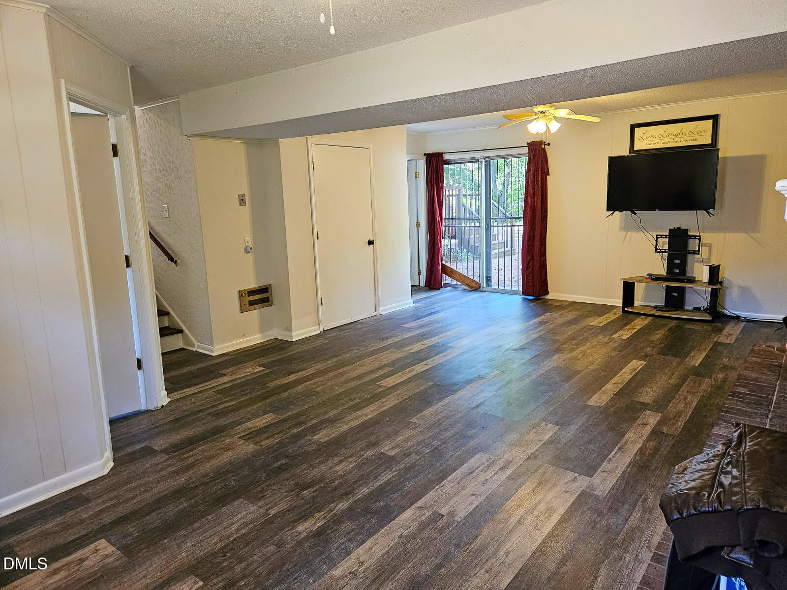 2212 Sanderford Road Raleigh, NC 27610 - Photo 26 of 28 a view of a livingroom with wooden floor and a flat screen tv
