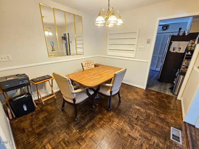 a dining room with furniture and chandelier