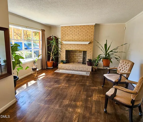 a living room with patio furniture and a floor to ceiling window