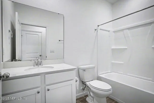 a bathroom with a sink toilet vanity and shower