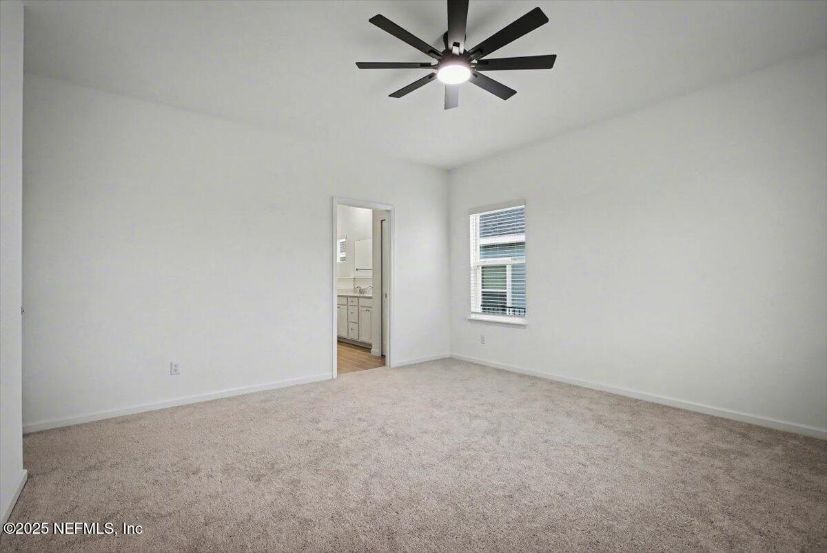 2692 Field Daisy Ln Green Cove Springs Green Cove Springs, FL 32043 - Photo 19 of 37 an empty room with windows and fan