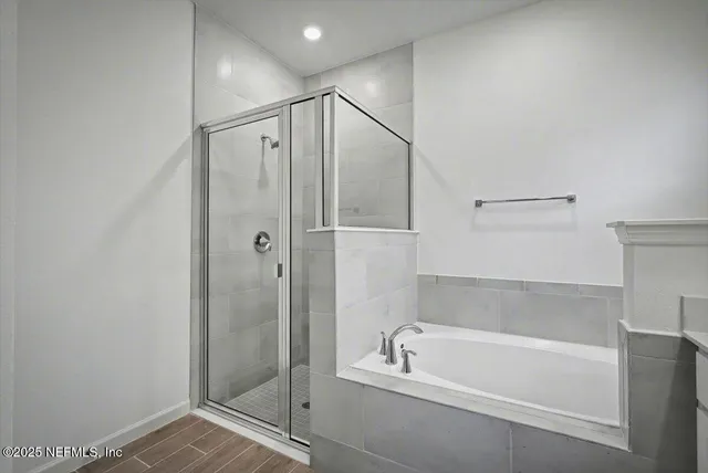 a bathroom with a bathtub and a shower