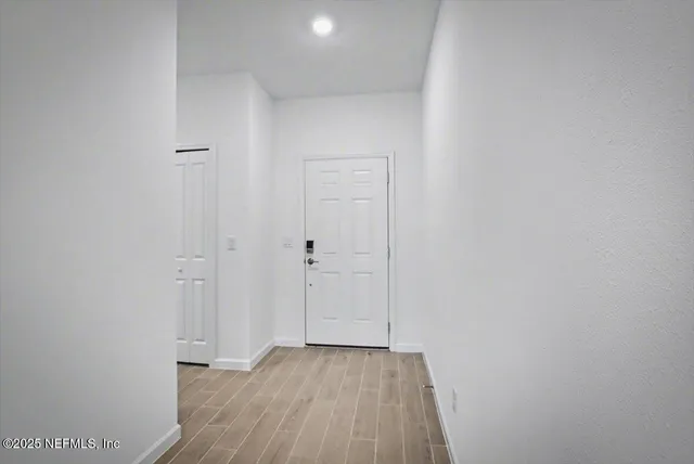 a view of a hallway with wooden floor
