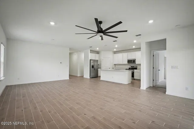 a view of kitchen with wooden floor and window