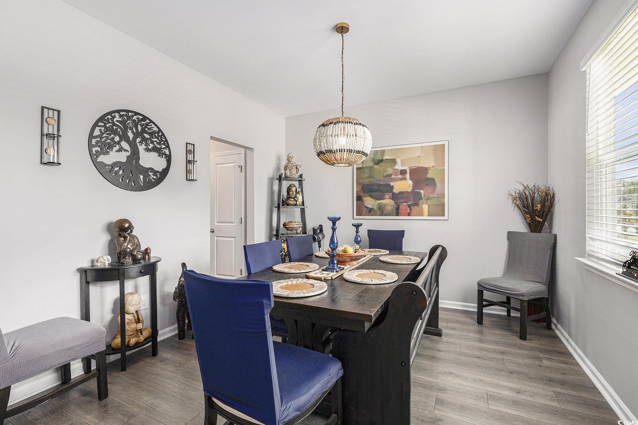 312 Cattle Drive Circle Myrtle Beach, SC 29588 - Photo 12 of 34 Dining room featuring a chandelier, plenty of natural light, and dark wood finished floors