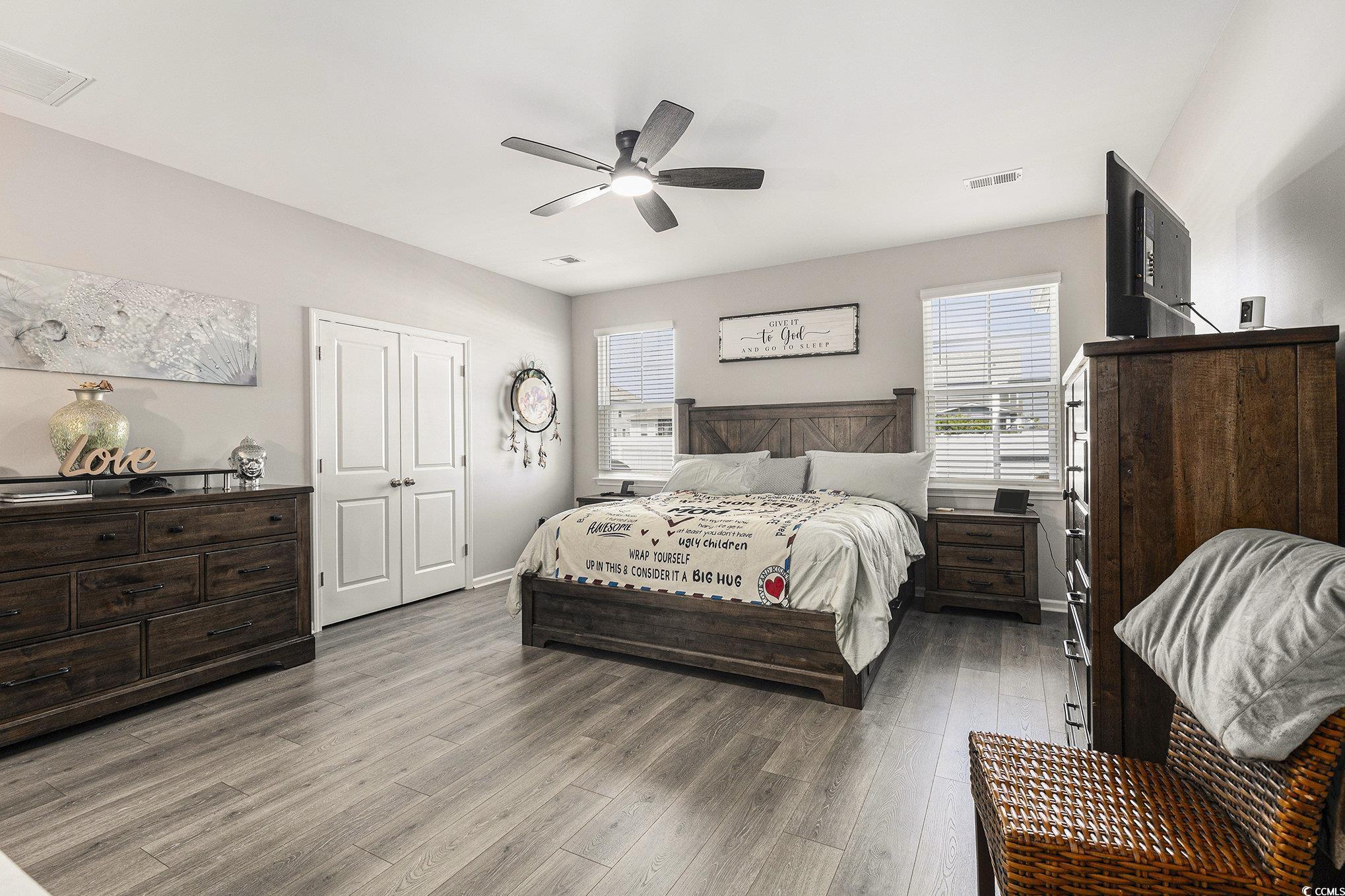 312 Cattle Drive Circle Myrtle Beach, SC 29588 - Photo 16 of 34 Bedroom with dark wood-style floors, a ceiling fan, and a desk