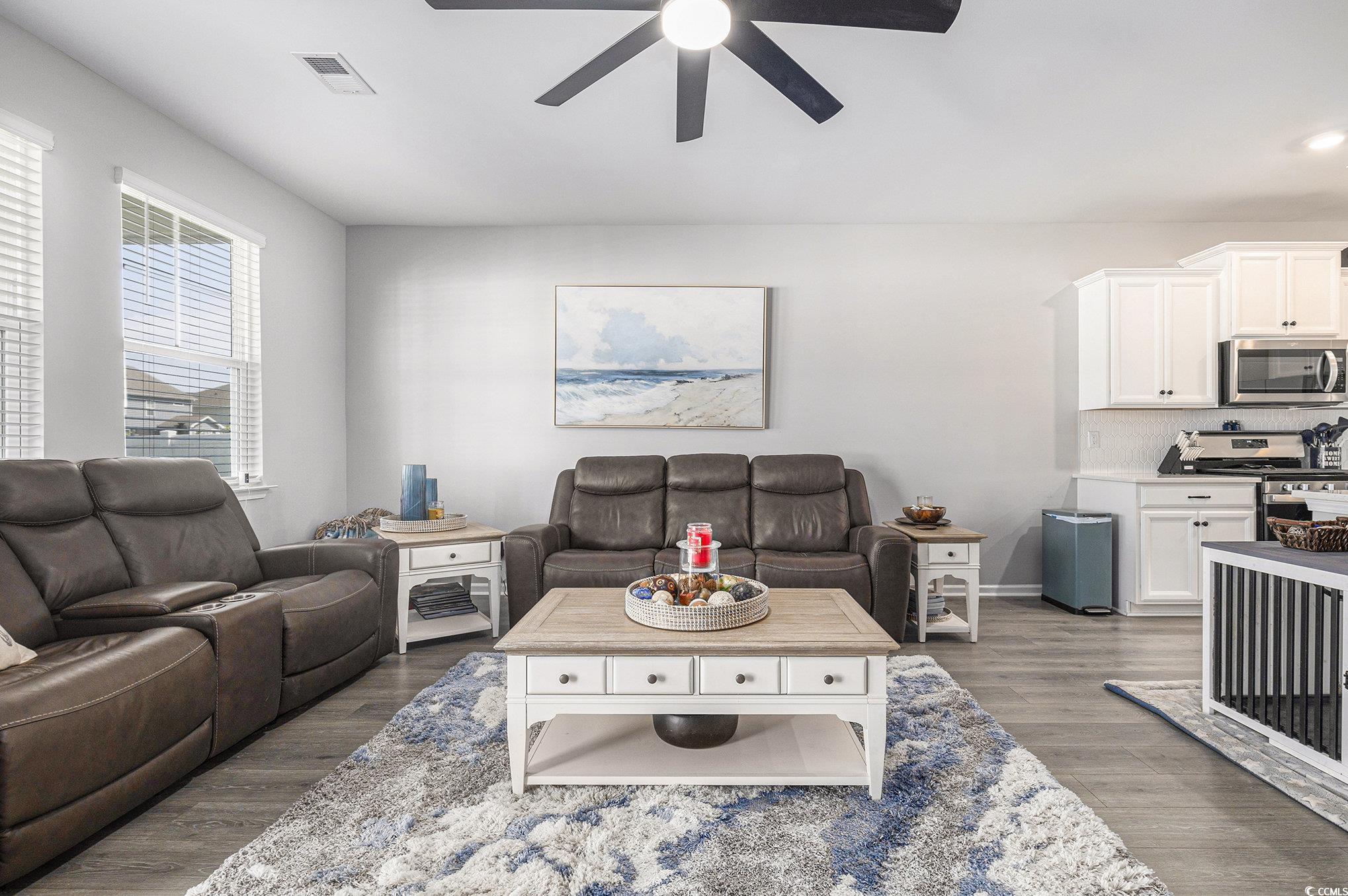 312 Cattle Drive Circle Myrtle Beach, SC 29588 - Photo 7 of 34 Living area with a ceiling fan and wood finished floors