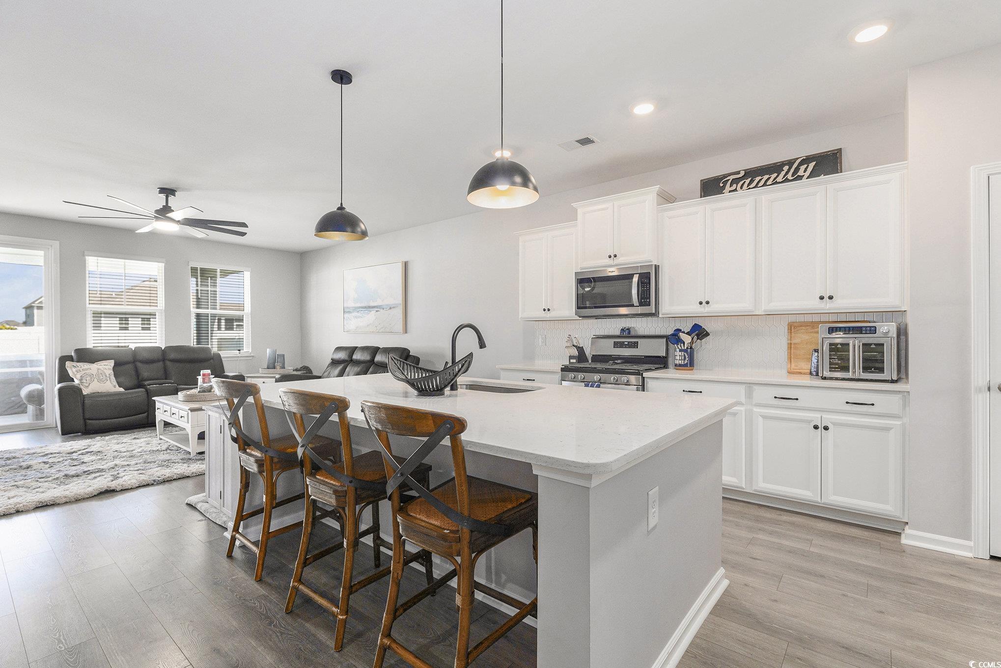 312 Cattle Drive Circle Myrtle Beach, SC 29588 - Photo 8 of 34 Living room with ceiling fan and wood finished floors