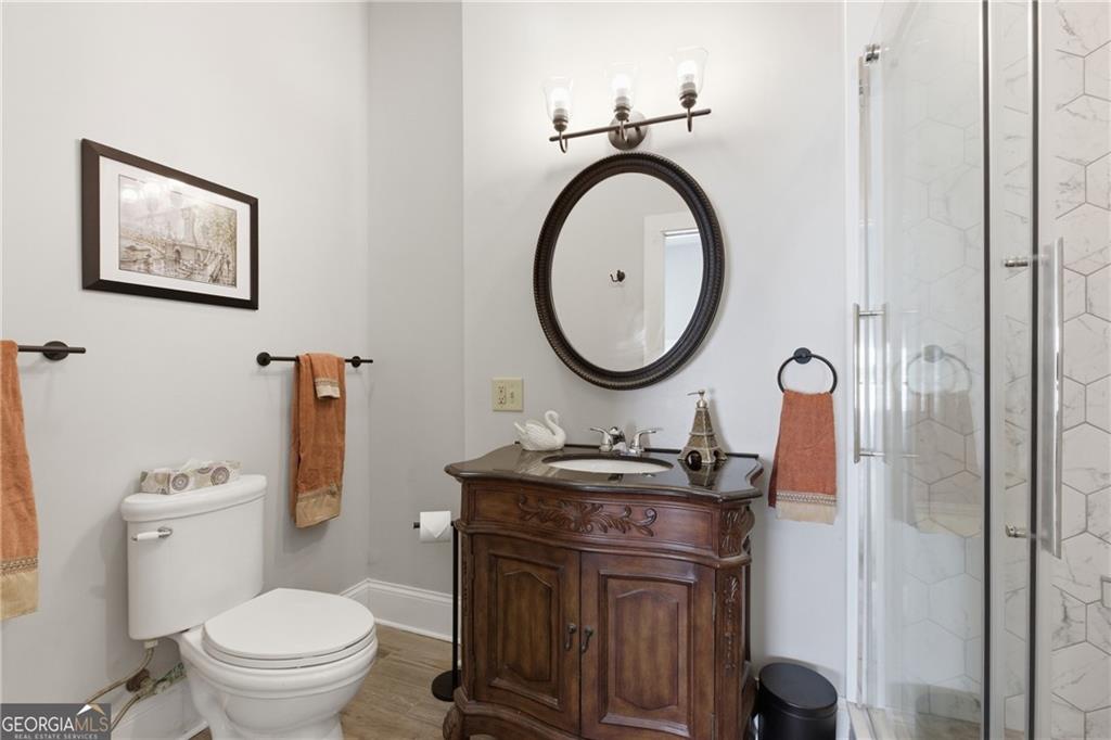 1910 Hancock Road Demorest, GA 30535 - Photo 12 of 29 a bathroom with a toilet a sink and a mirror