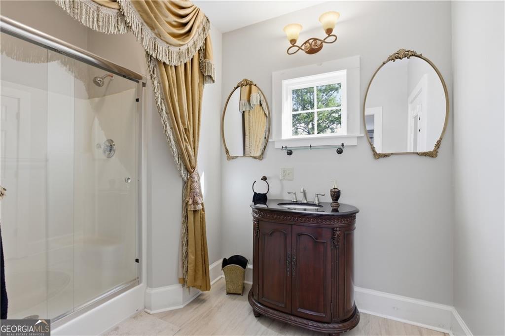 1910 Hancock Road Demorest, GA 30535 - Photo 17 of 29 a bathroom with a sink a mirror and a shower