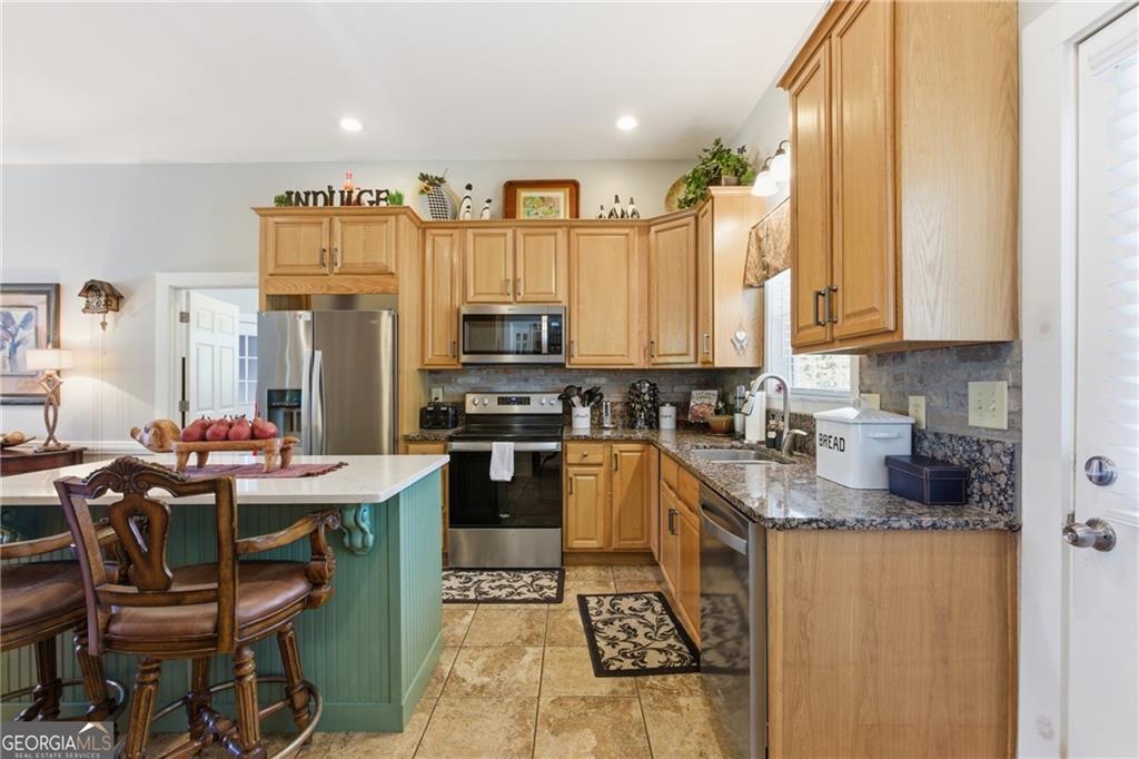 1910 Hancock Road Demorest, GA 30535 - Photo 20 of 29 a kitchen with stainless steel appliances kitchen island granite countertop a sink a stove a refrigerator cabinets and chairs