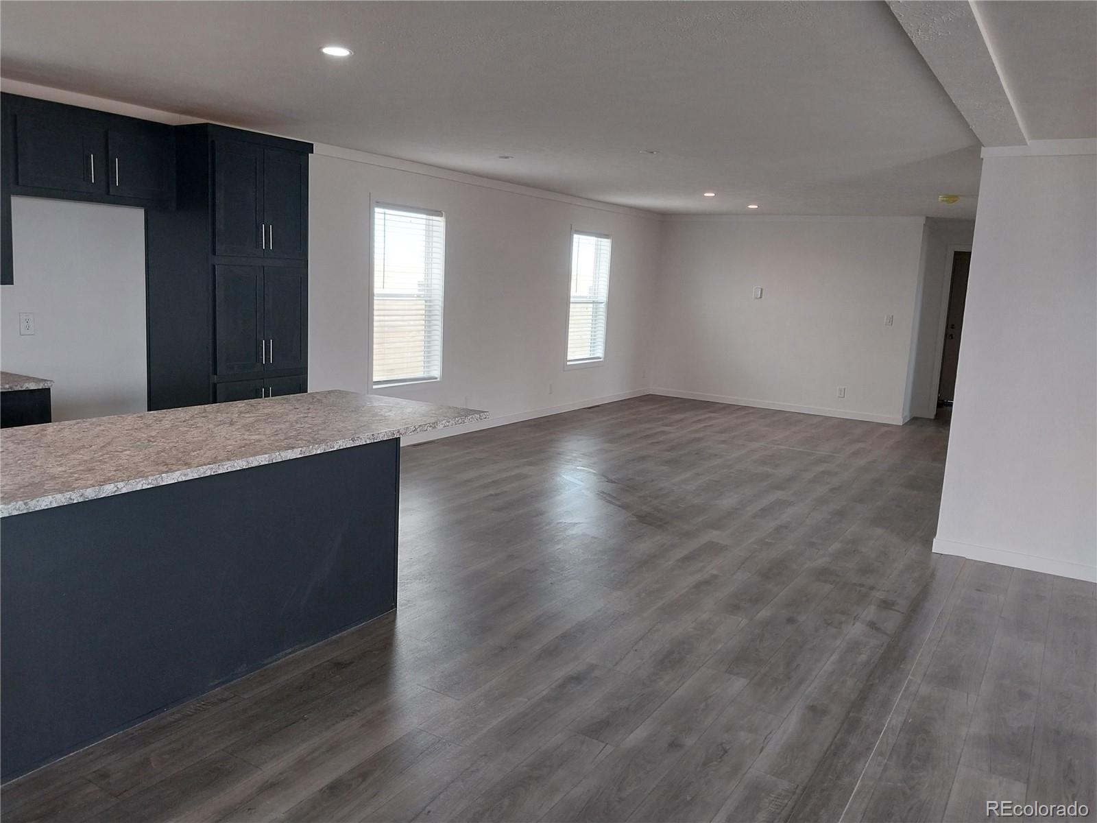 776 North Ramah Highway Yoder, CO 80864 - Photo 11 of 18 a view of an empty room with wooden floor and a window