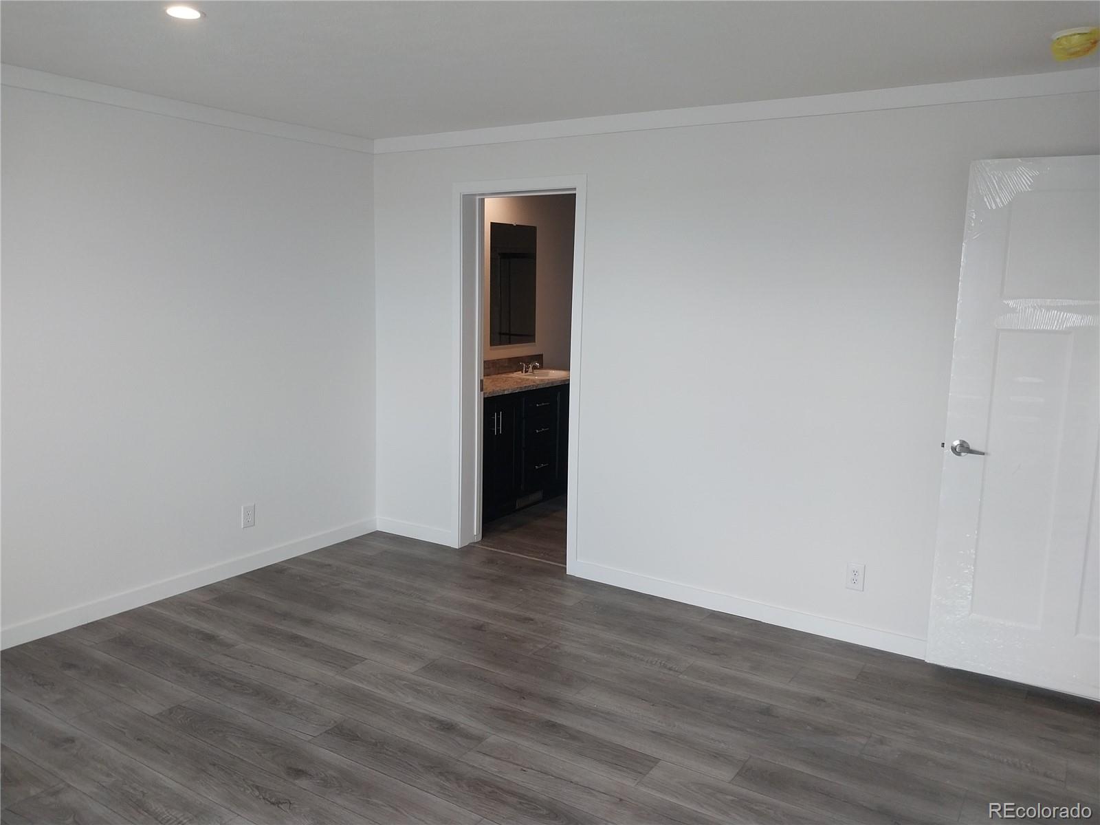 776 North Ramah Highway Yoder, CO 80864 - Photo 10 of 18 a view of an empty room with wooden floor and closet