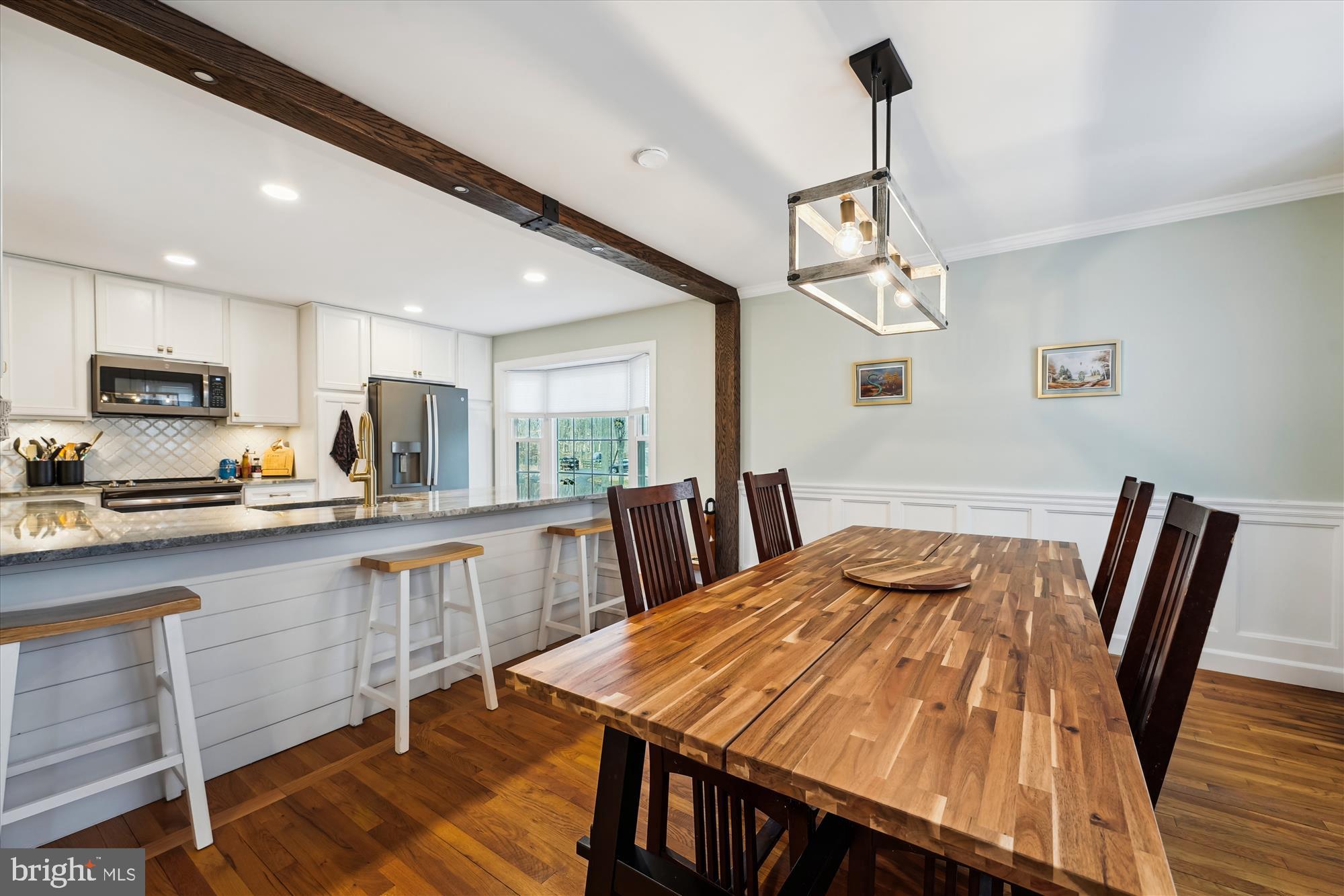 5404 Well Spring Road La Plata, MD 20646 - Photo 10 of 34 a kitchen with stainless steel appliances granite countertop a kitchen island hardwood floor sink stove dining table and chairs