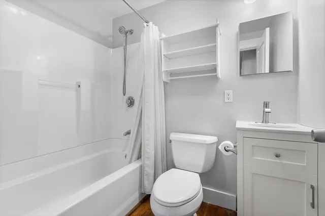 a bathroom with a toilet sink and shower