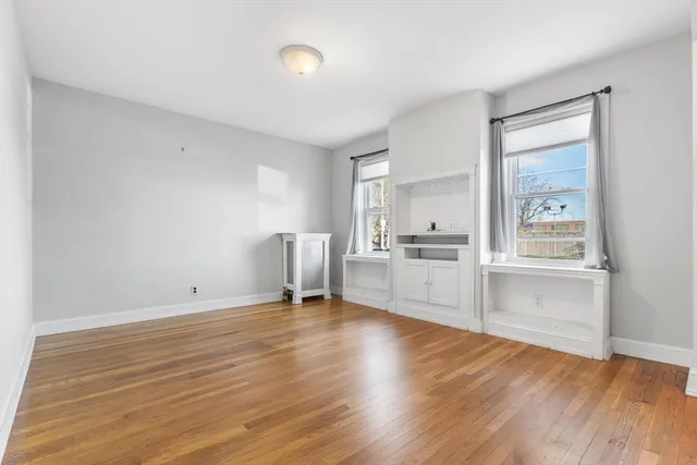 a view of a kitchen with wooden floor and a sink