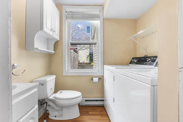 a bathroom with a toilet a sink and a mirror