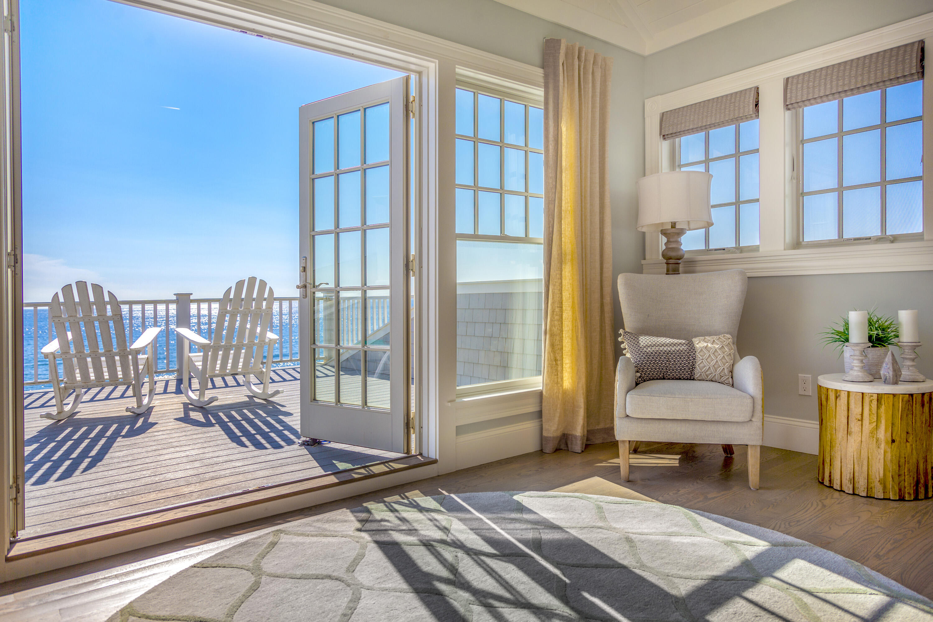 a living room with furniture and a floor to ceiling window