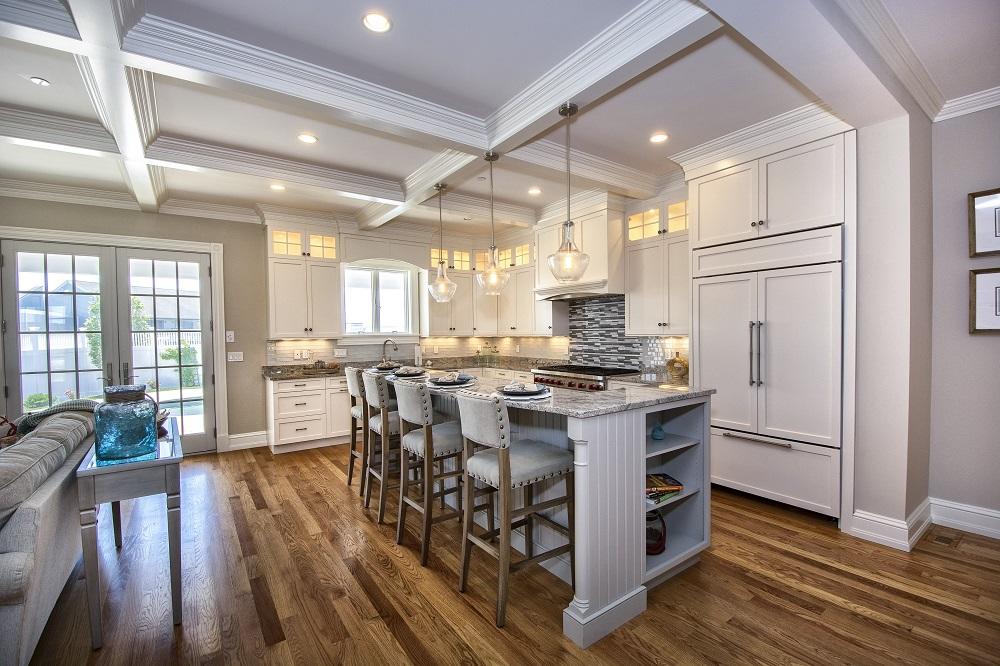 12 Coastline Drive Mashpee, MA 02649 - Photo 12 of 46 a kitchen with stainless steel appliances granite countertop a stove refrigerator and a dining table with wooden floor