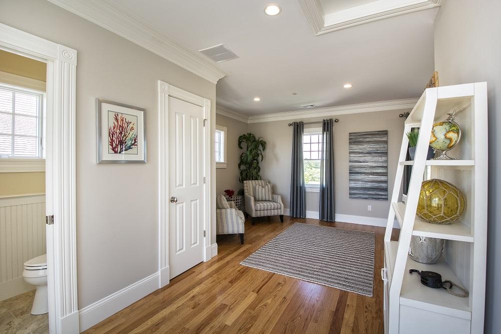 12 Coastline Drive Mashpee, MA 02649 - Photo 24 of 46 a bedroom with a bed and wooden floor