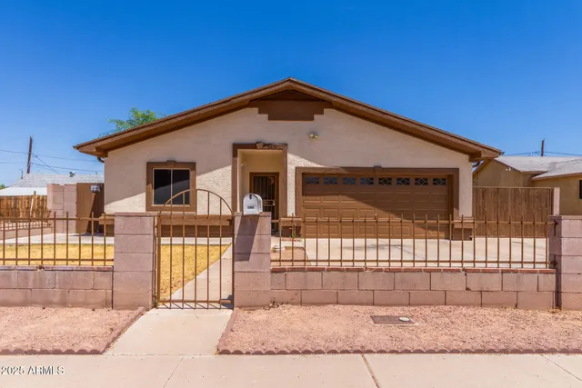 a view of a house with wooden fence