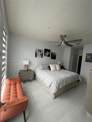 a bedroom with a bed and window