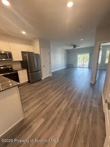 a view of a livingroom with wooden floor