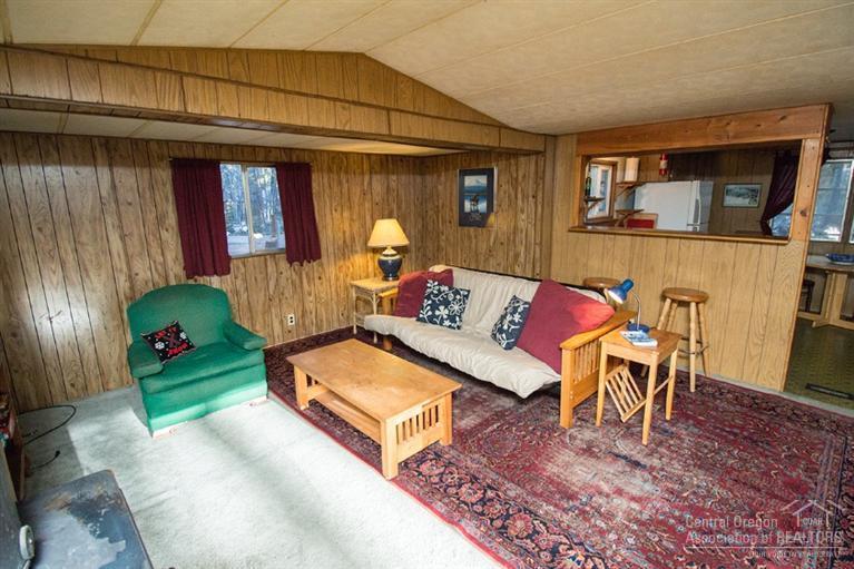 16804 Covina Road Bend, OR 97707 - Photo 10 of 16 a living room with furniture and a wooden floor