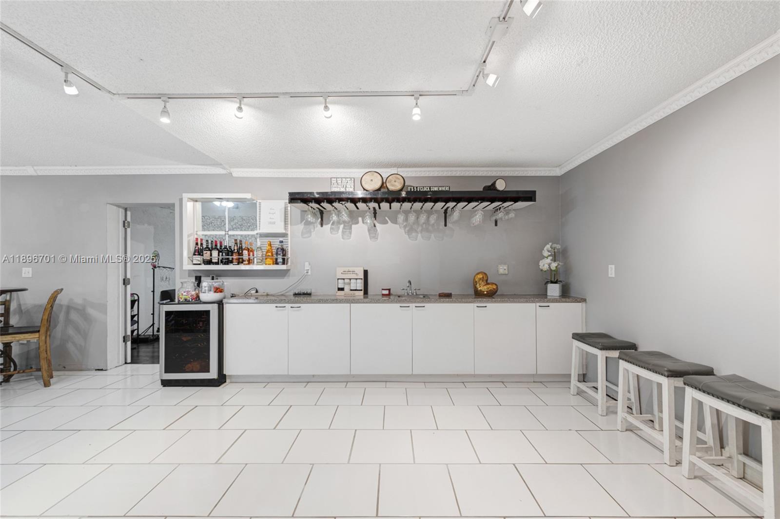 19491 Southwest 216th Street Miami, FL 33187 - Photo 11 of 37 a kitchen with cabinets and window