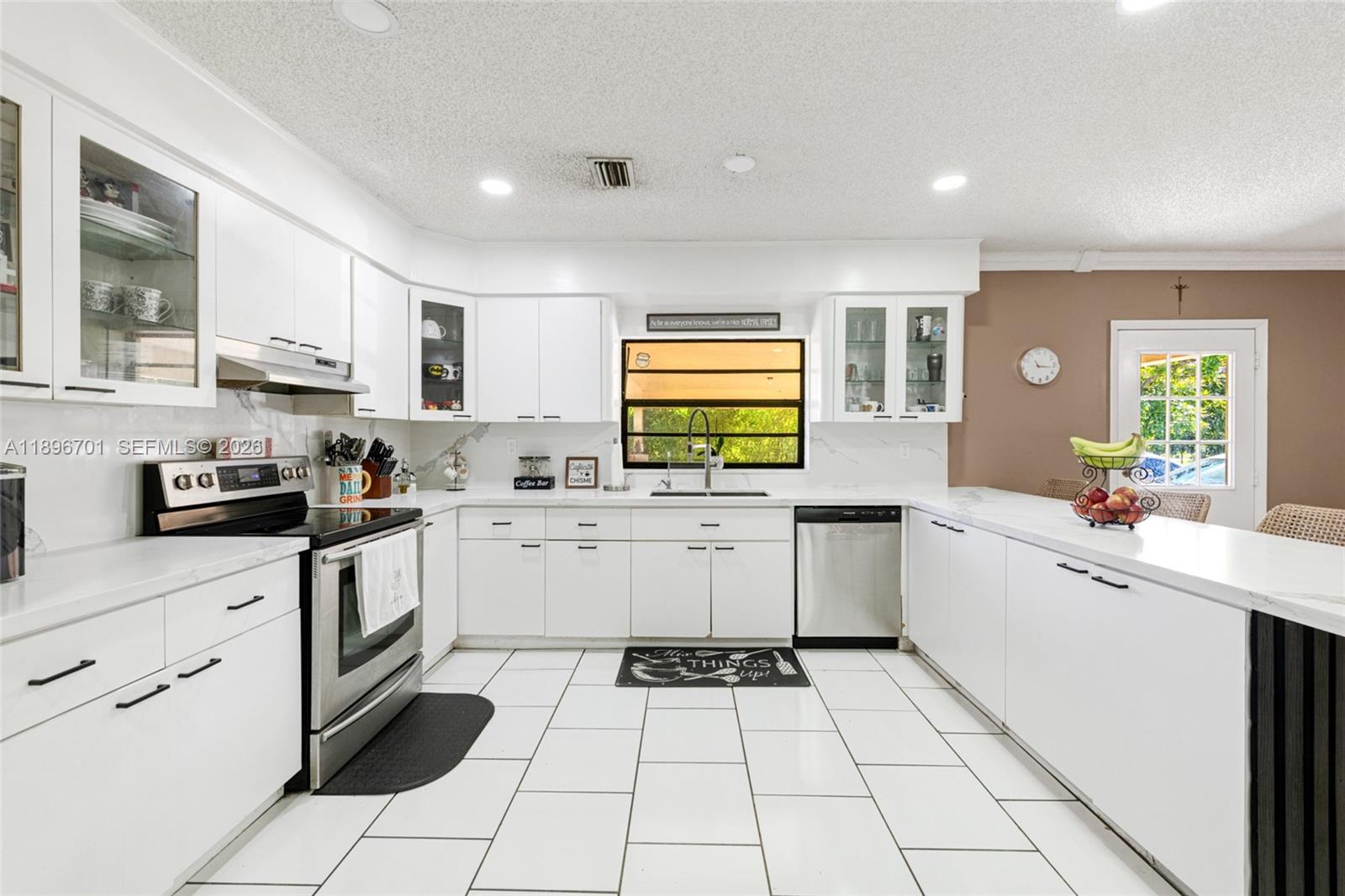 19491 Southwest 216th Street Miami, FL 33187 - Photo 16 of 32 a kitchen with a cabinets and appliances
