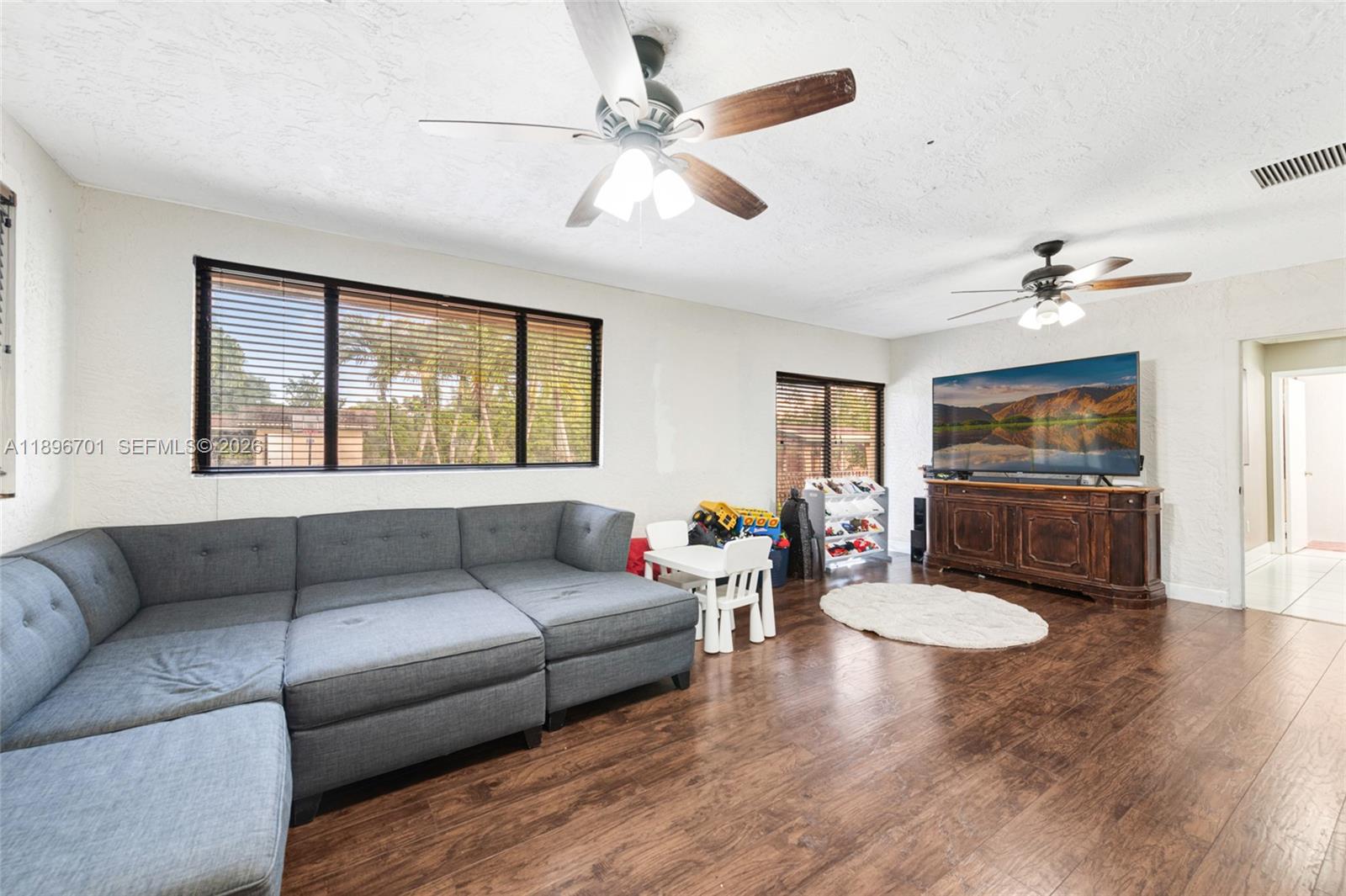 19491 Southwest 216th Street Miami, FL 33187 - Photo 18 of 32 a living room with furniture and a window