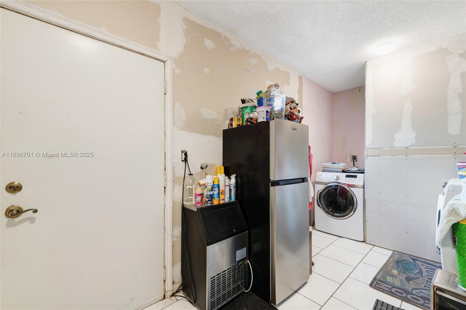 19491 Southwest 216th Street Miami, FL 33187 - Photo 19 of 37 a white refrigerator freezer sitting inside of a kitchen