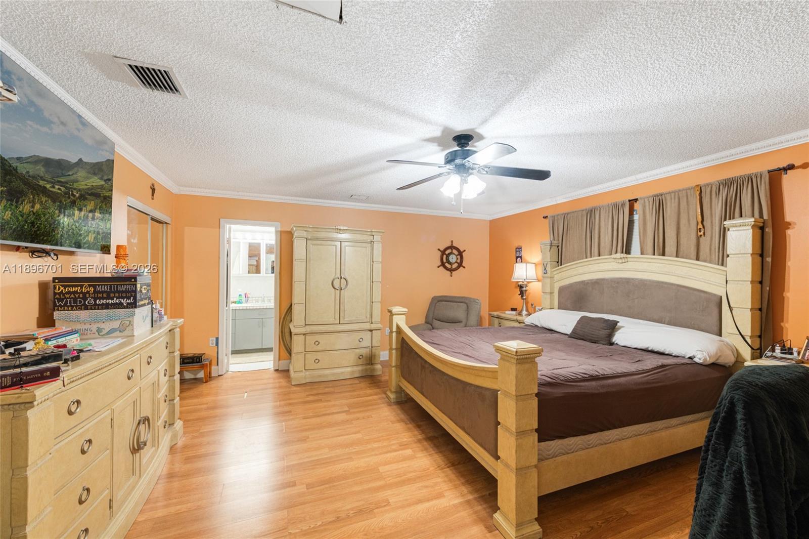 19491 Southwest 216th Street Miami, FL 33187 - Photo 20 of 32 a bedroom with a bed and a chandelier