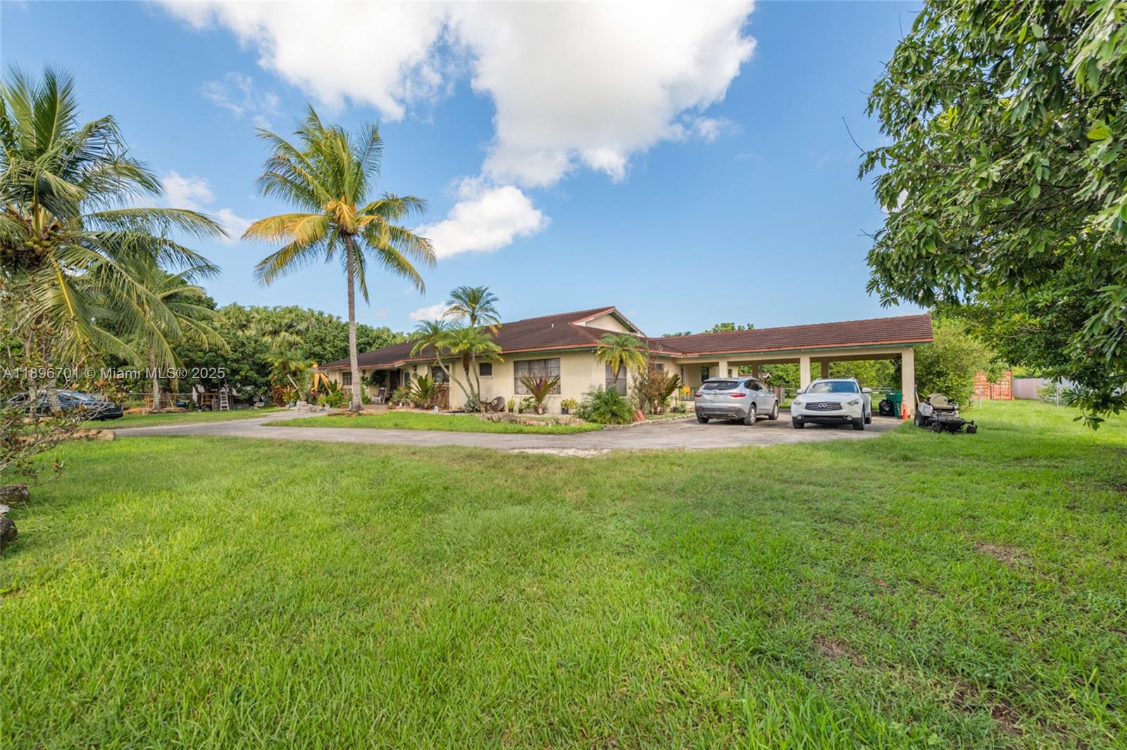 19491 Southwest 216th Street Miami, FL 33187 - Photo 2 of 37 a front view of house with yard and trees