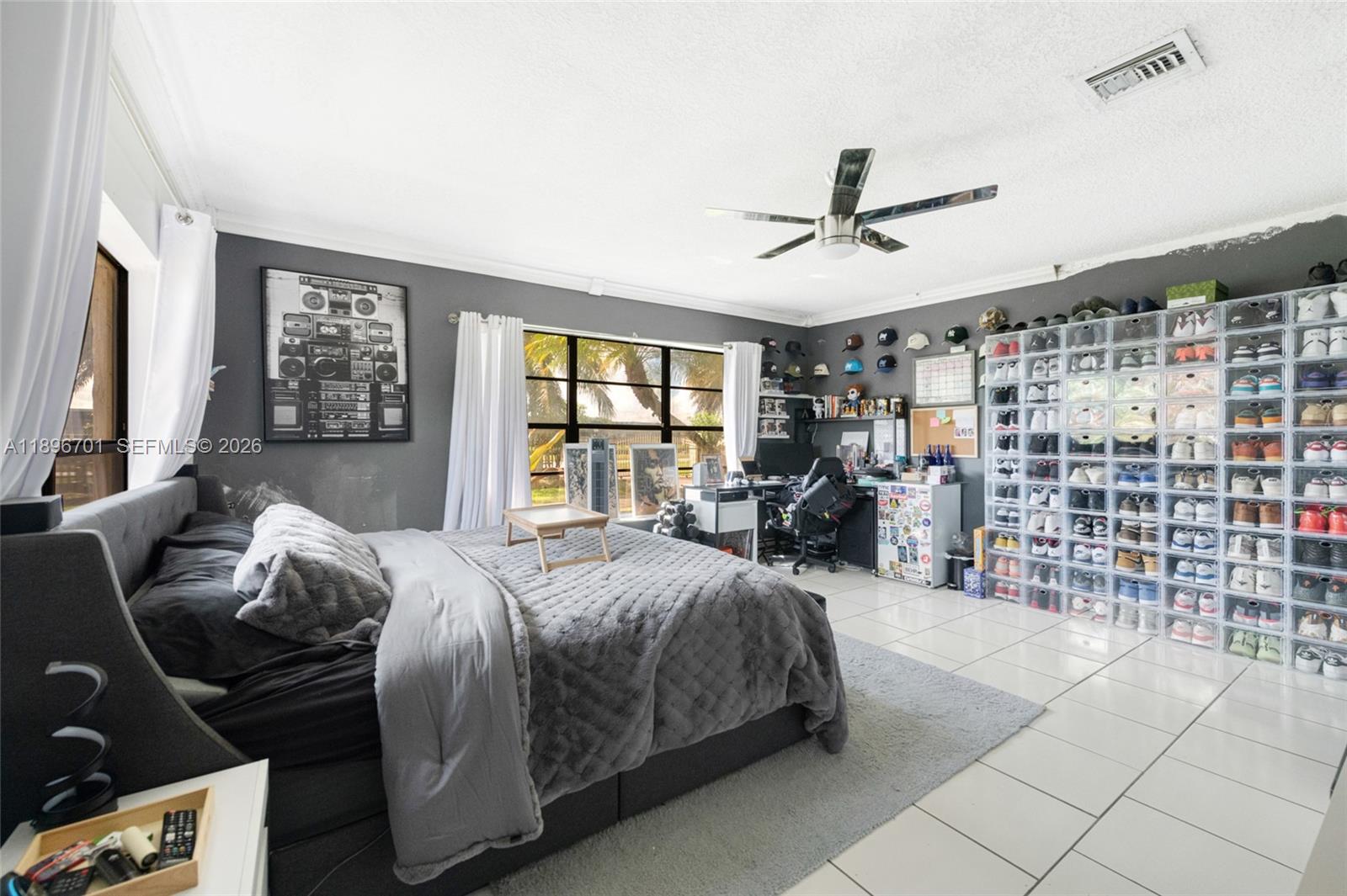 19491 Southwest 216th Street Miami, FL 33187 - Photo 23 of 32 a bed room with a bed and a large window
