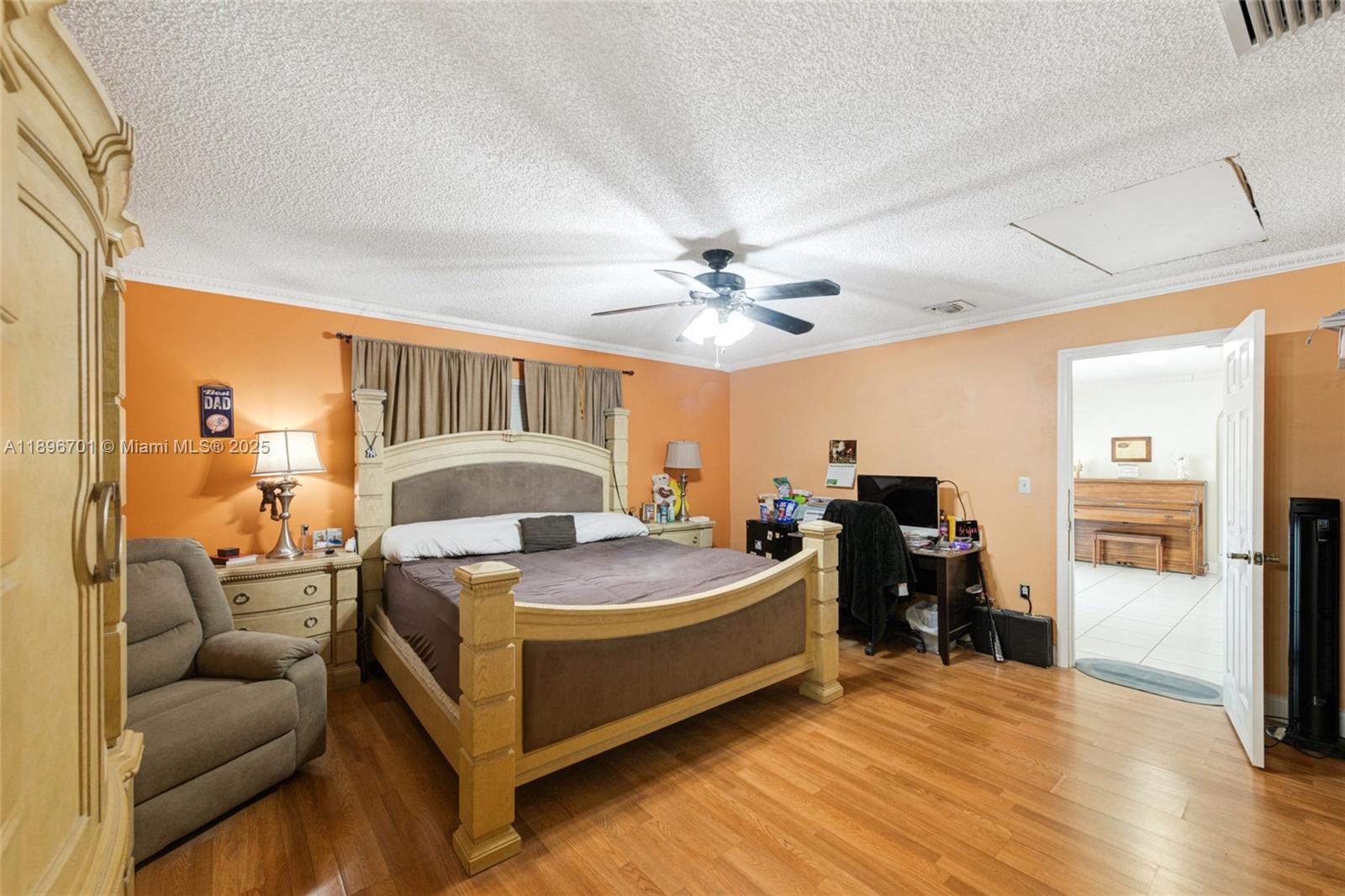 19491 Southwest 216th Street Miami, FL 33187 - Photo 24 of 37 a bed room with a bed and a chandelier