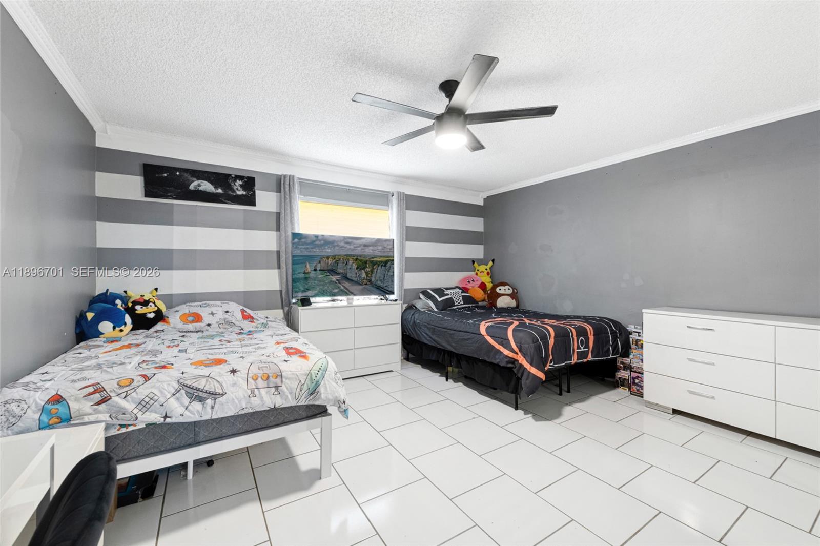 19491 Southwest 216th Street Miami, FL 33187 - Photo 24 of 32 a bedroom with a bed and a window