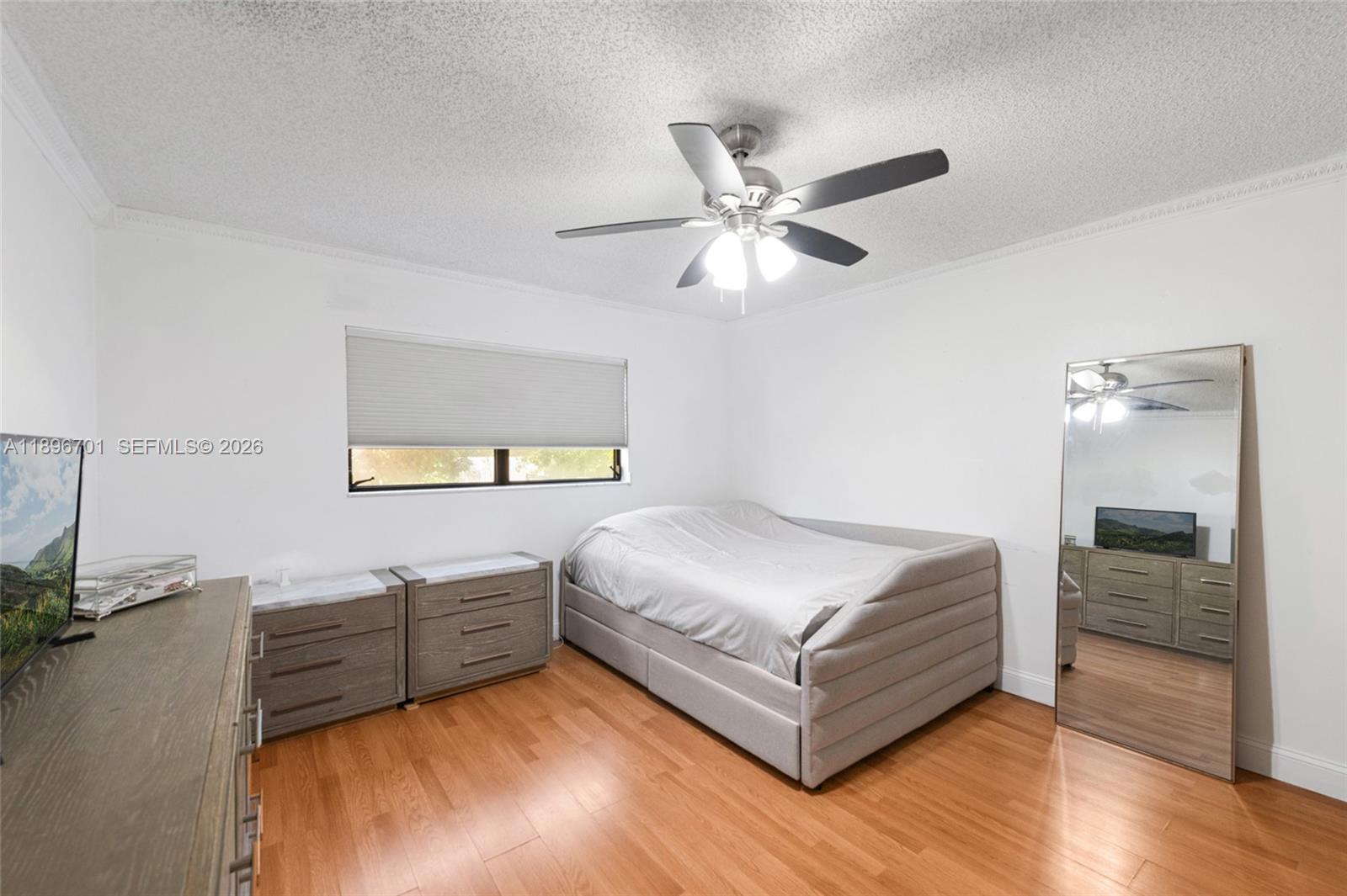 19491 Southwest 216th Street Miami, FL 33187 - Photo 25 of 32 a living room with a bed furniture and a ceiling fan
